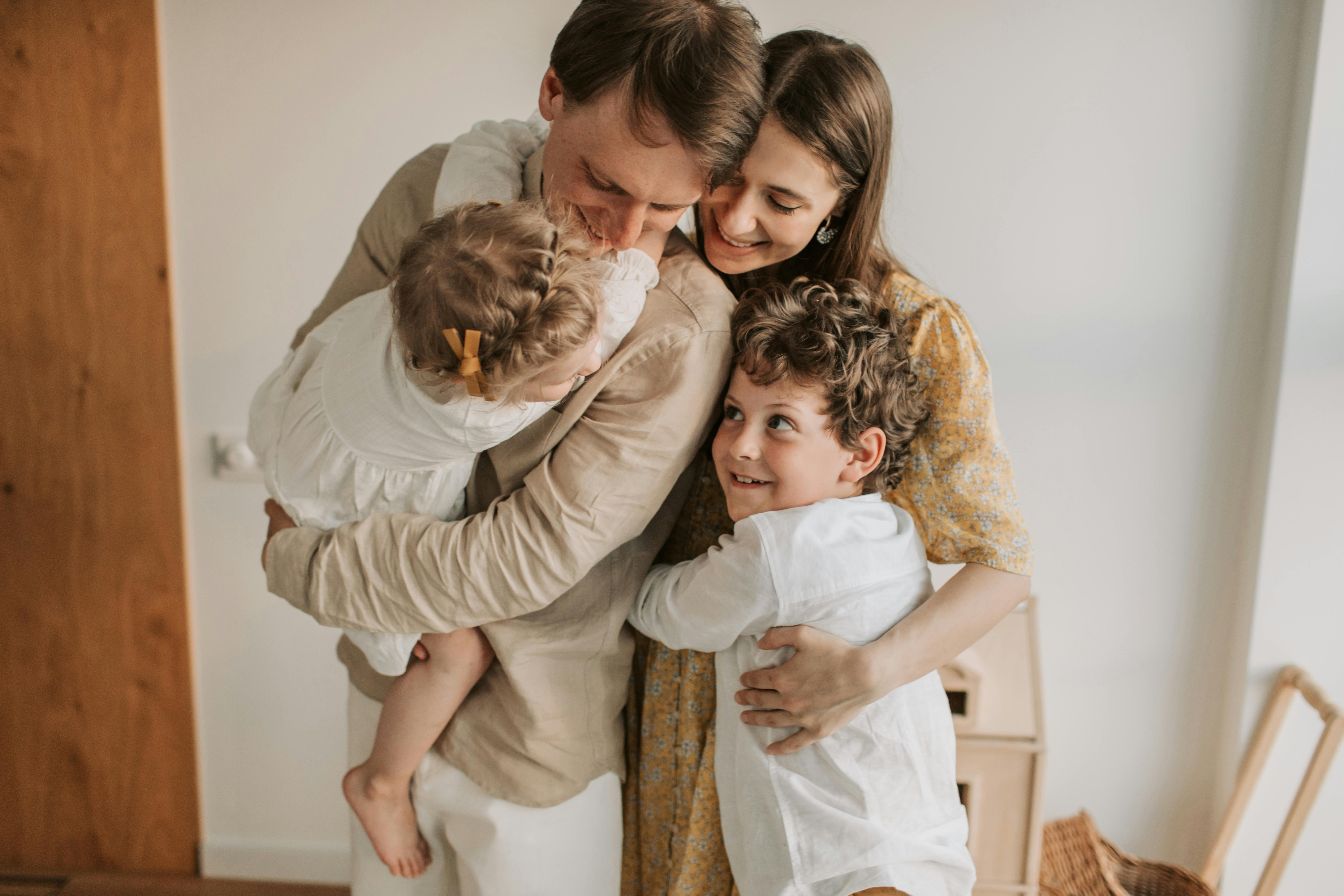 Family smiling at home – confident their children’s care is covered with simplified Tax-Free Childcare payments